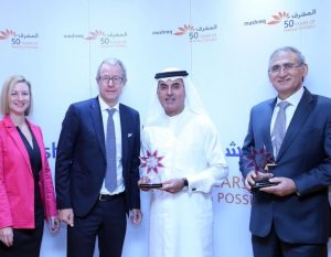 Abdul Aziz Al Ghurair holding the Corporate Wellness Leader of the Year award