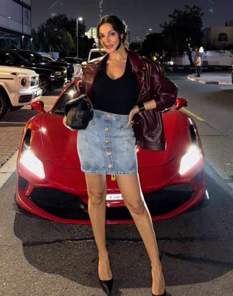 Nadine Nassib Njeim posing with her car