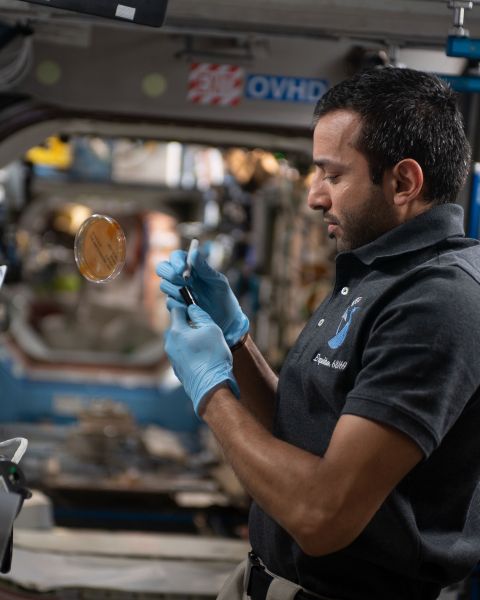 Sultan Al Neyadi conducting an experiment at the ISS