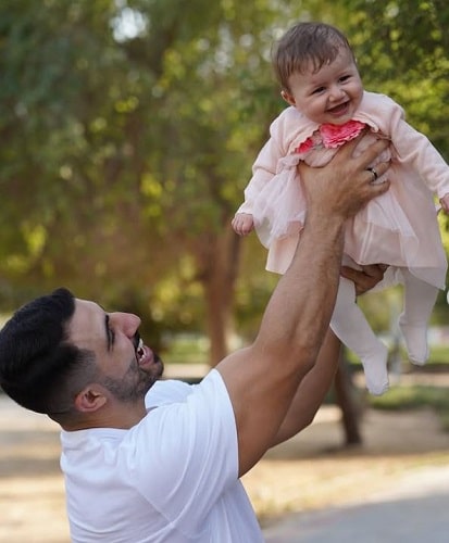 Khalid Alherani with his daughter