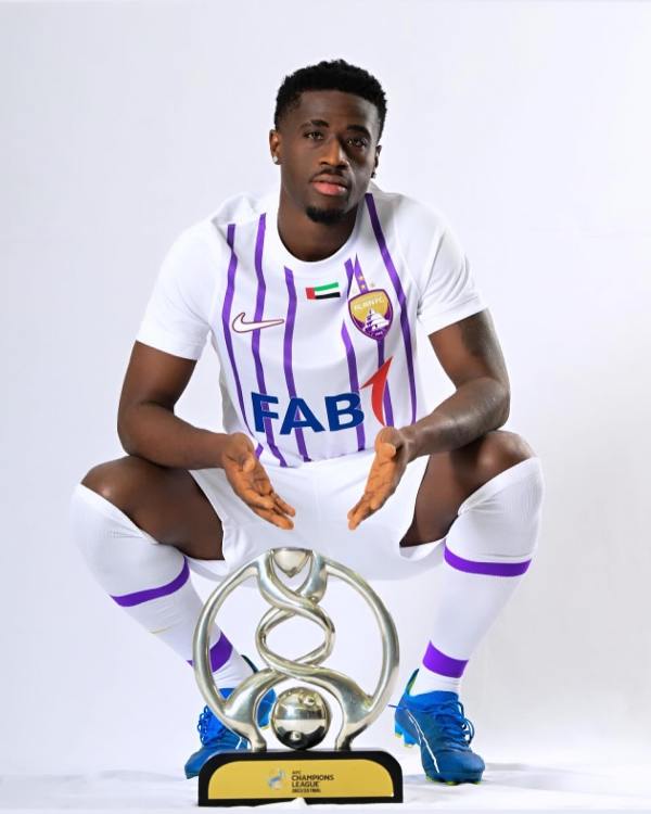 Photo of Kouame Autonne posing with the AFC trophy