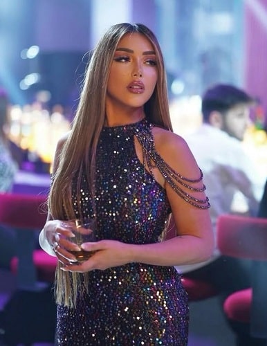 Sarah Ahmed Salama holding a glass of alcohol