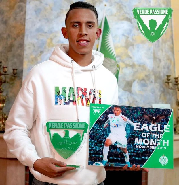 Soufiane Rahimi holding Eagle of the Month award