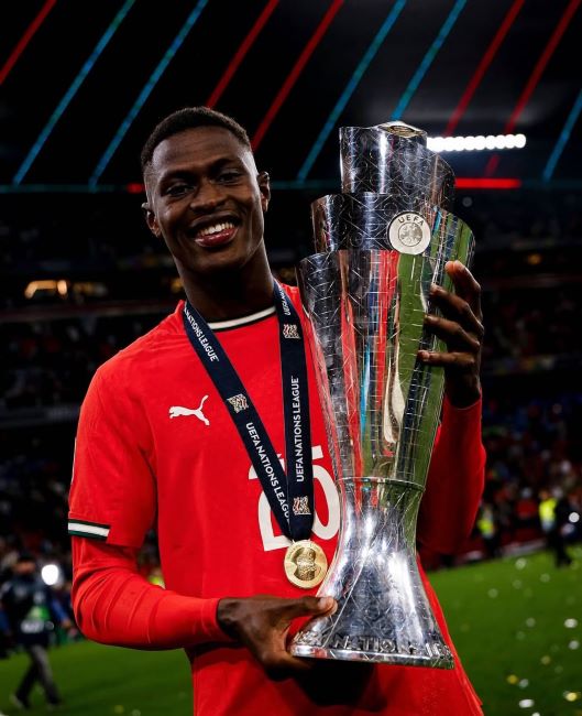 Nuno Mendes holding the UEFA Nations League trophy (2025)